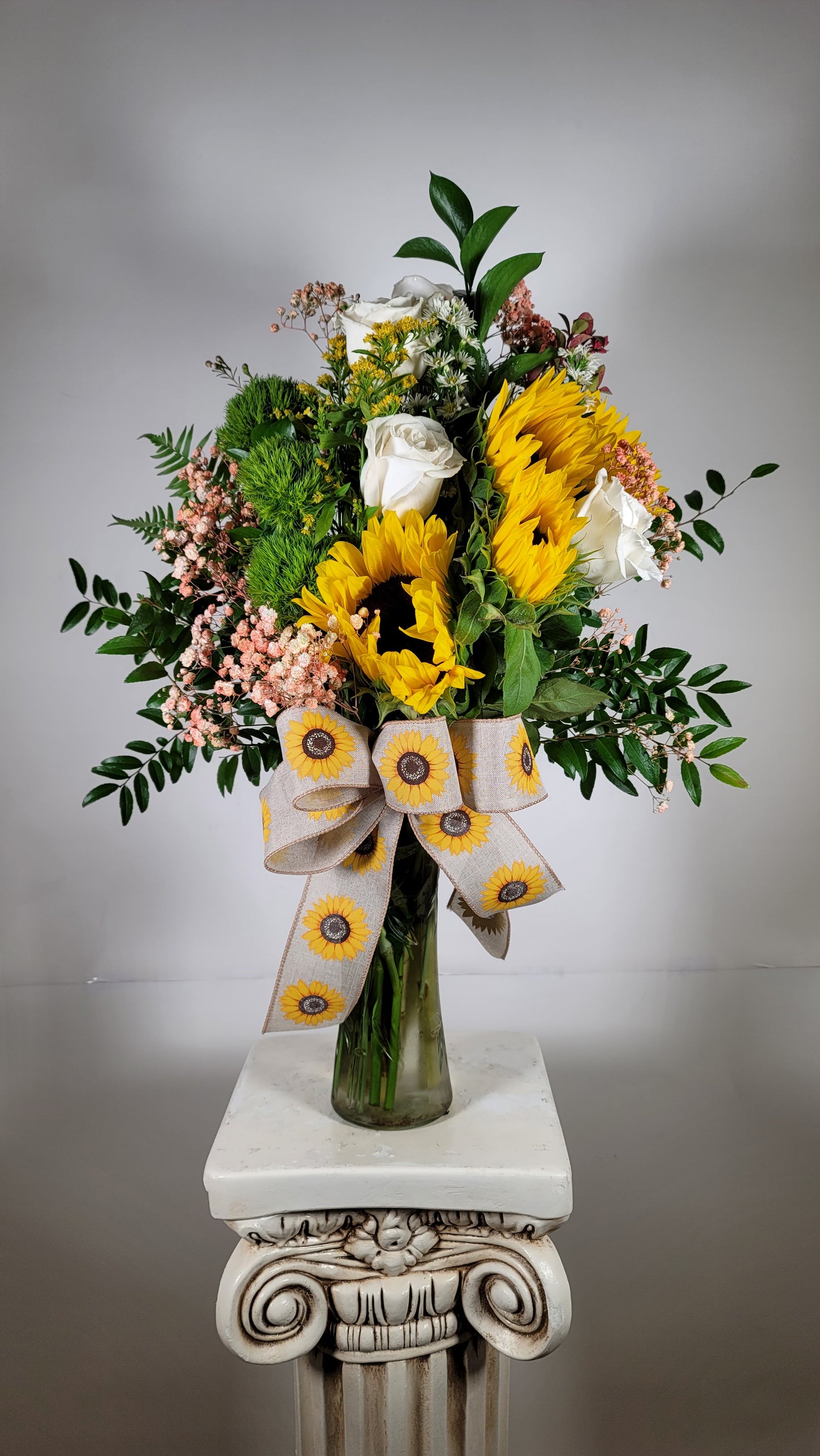 Cheerful sunflower vase arrangement with white roses accent flowers and fresh greenery in Houston