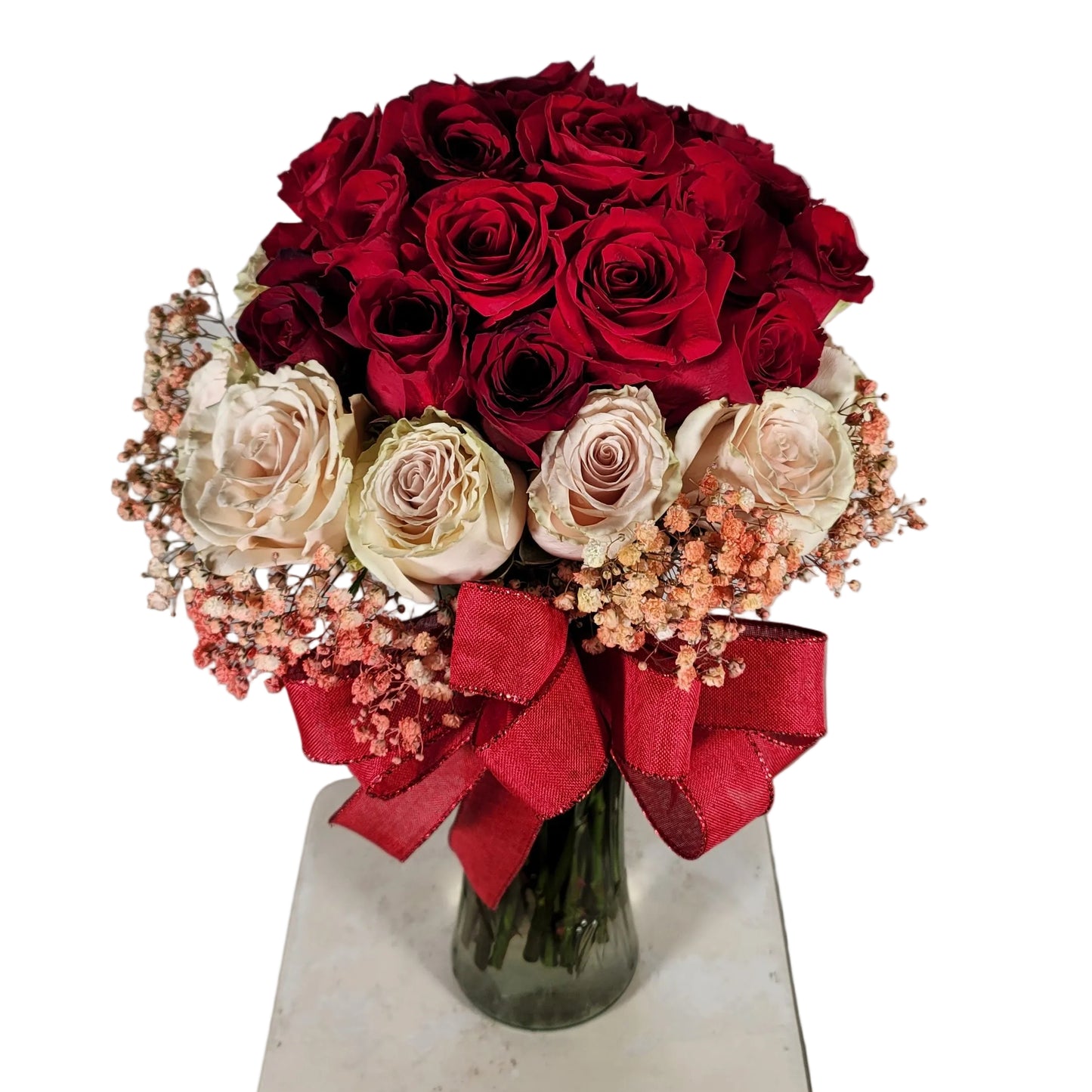 Red and blush rose bouquet in clear glass vase with ribbon for Houston flower delivery