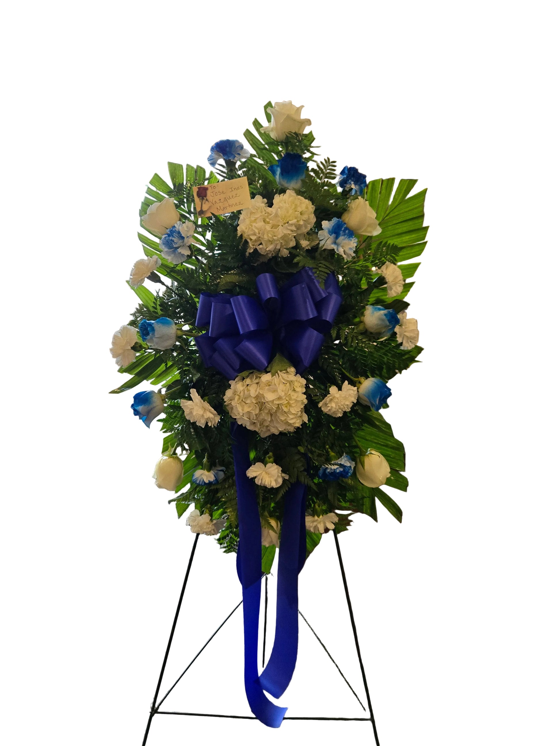Royal blue and white standing spray on easel with ribbon for funeral flowers in Houston