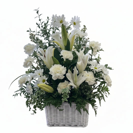 All white sympathy basket with lilies carnations daisies and fresh greenery by Houston florist