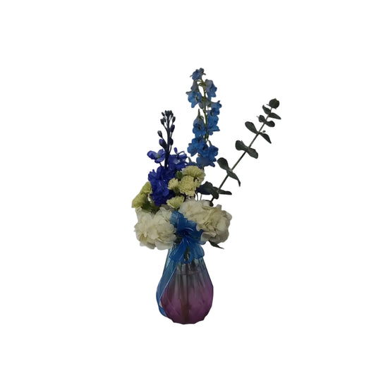 Blue delphinium and white hydrangea vase arrangement with eucalyptus and ribbon by Houston florist