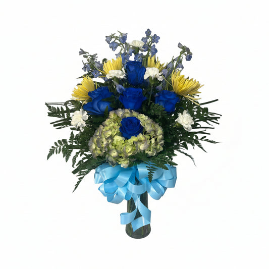 Blue and yellow floral vase arrangement with blue roses delphinium hydrangea and fresh greenery by Houston florist