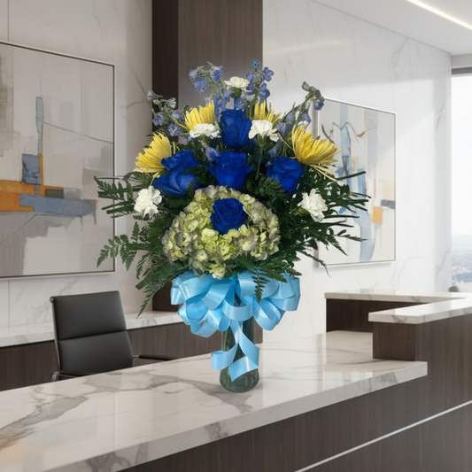 Blue and yellow rose vase arrangement with hydrangea and greenery for Houston flower delivery