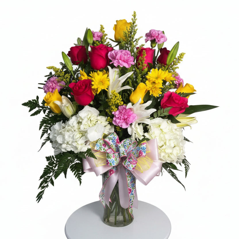 Bright mixed flower vase arrangement with hydrangeas roses lilies and yellow blooms for Houston flower delivery