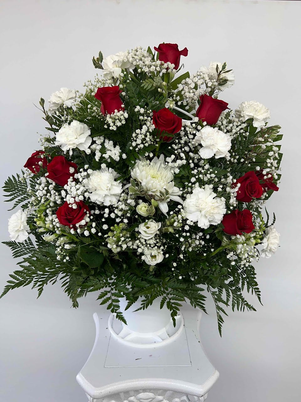 Funeral flower basket with red roses white carnations and baby breath for Houston flower delivery