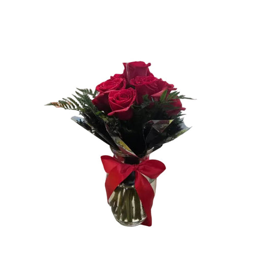 Half dozen red roses in classic glass vase with fresh greenery and red satin ribbon by Houston florist