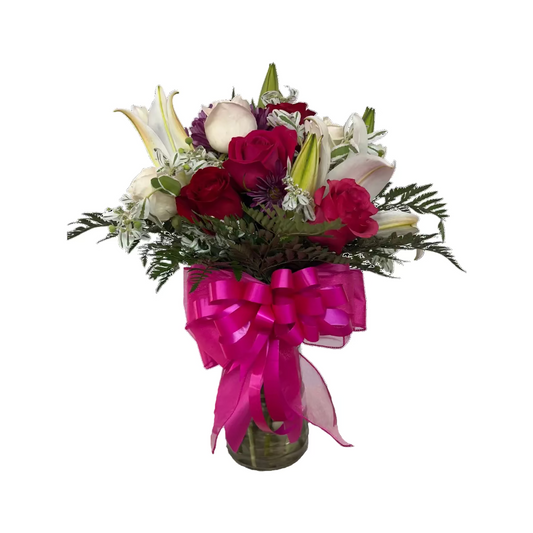 Pink lily and rose vase arrangement with fresh greenery and bright ribbon by Houston florist