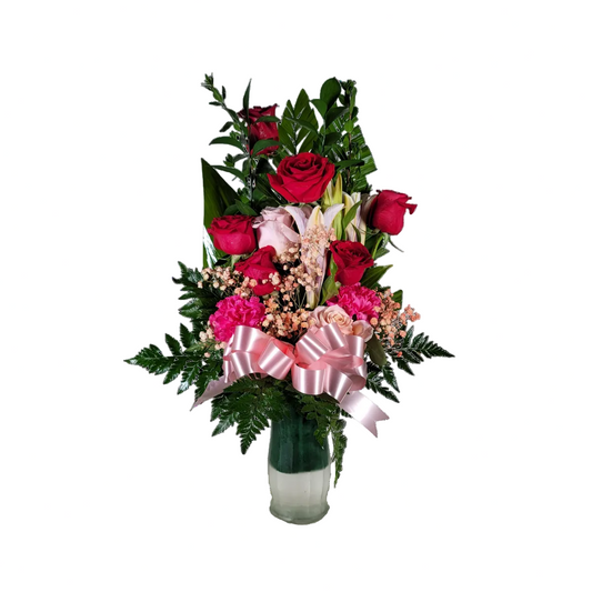 Pink and red rose lily vase arrangement with carnations greenery and ribbon by Houston florist