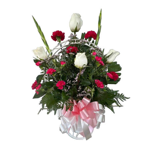Pink and white sympathy basket with white roses hot pink carnations greenery and ribbon by Houston florist