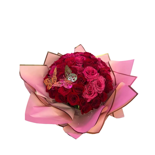 Premium red and pink rose bouquet with luxury pink wrap and butterfly accent by Houston florist