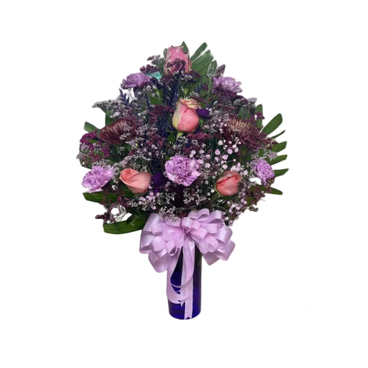 Purple and pink elegance vase arrangement with roses carnations mums and fresh greenery by Houston florist