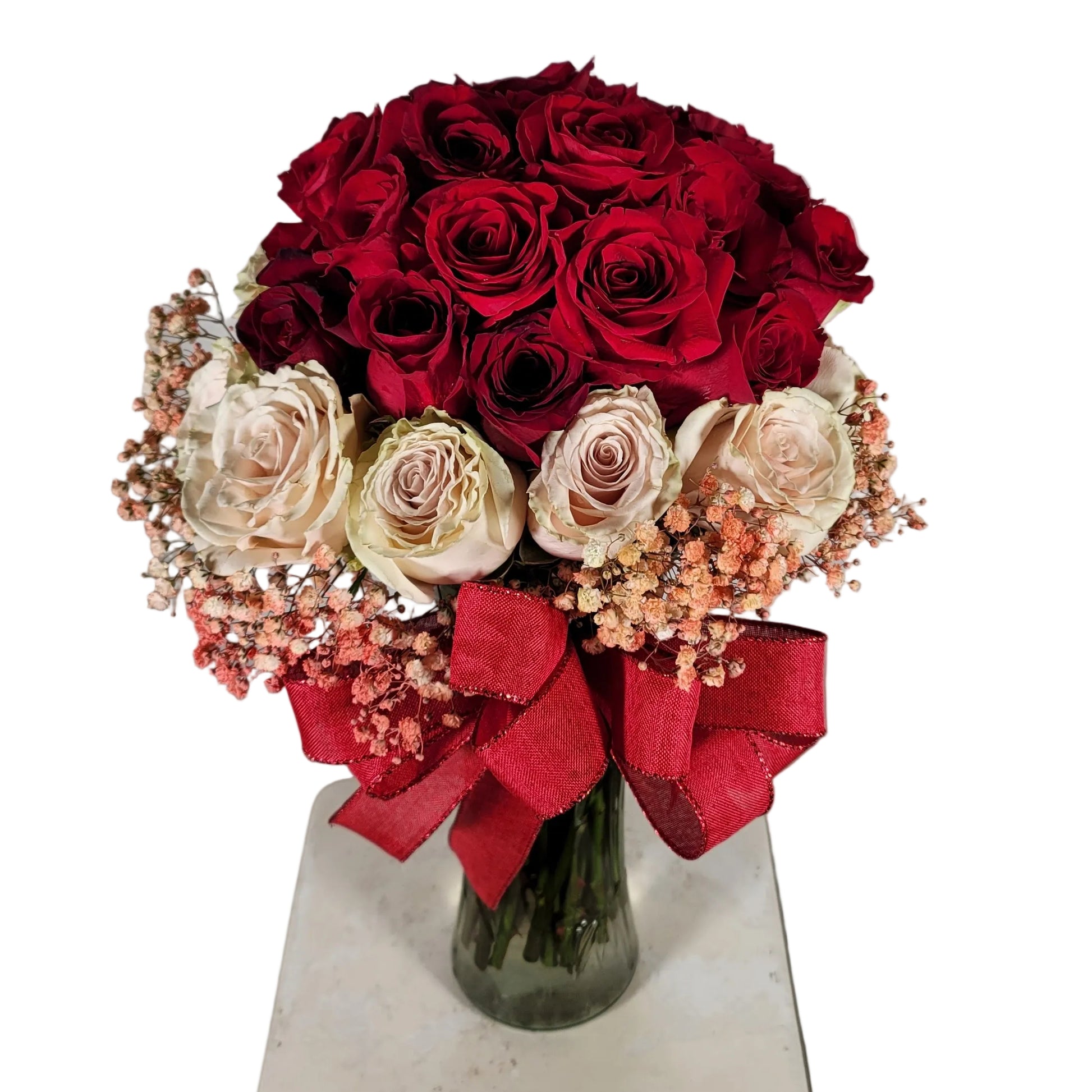 Red and blush rose bouquet in clear glass vase with ribbon for Houston flower delivery
