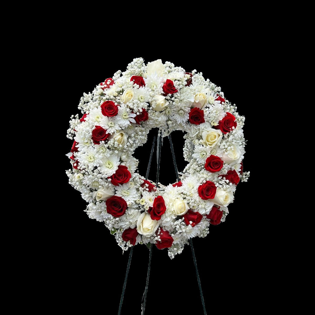 Red and white funeral wreath with roses mums and fresh greenery on easel stand in Houston