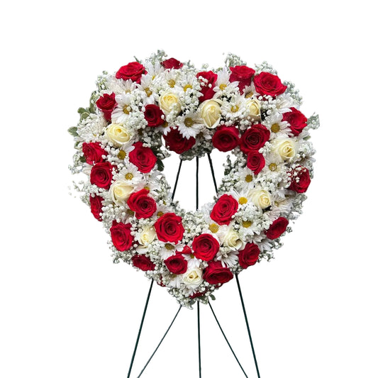 Red and white heart sympathy wreath with roses white daisies baby breath and fresh greenery by Houston florist
