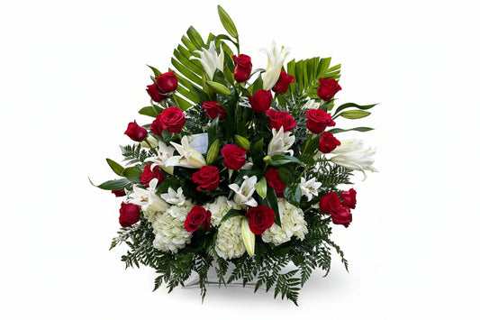 Red and white sympathy basket arrangement with roses lilies hydrangeas and fresh greenery by Houston florist