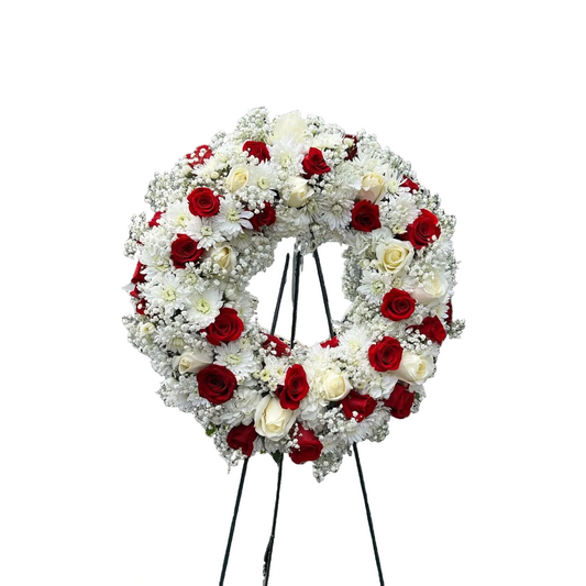 Red and white sympathy wreath with roses white mums baby breath and fresh greenery by Houston florist