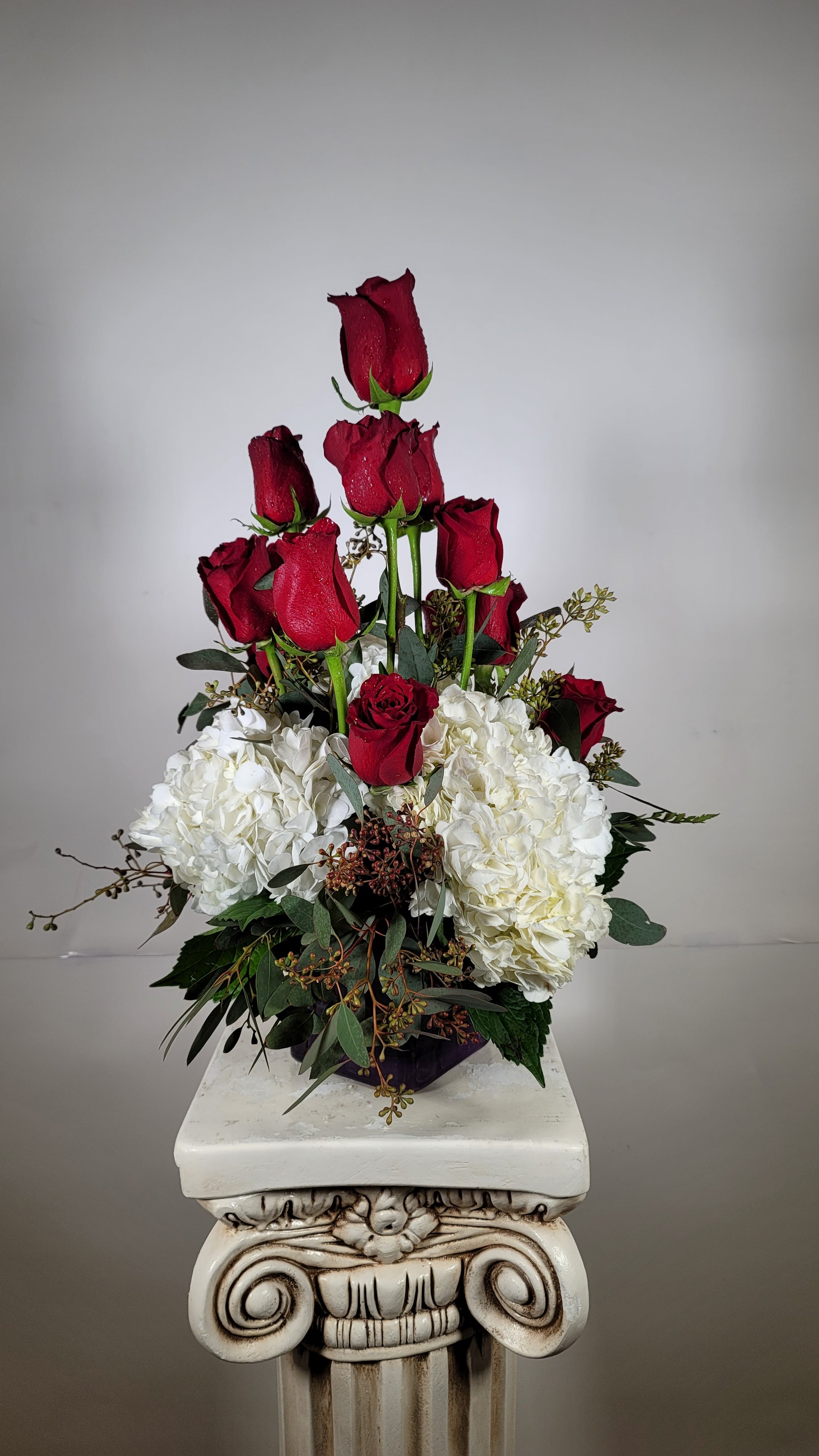 Romantic arrangement with red roses white hydrangeas and eucalyptus for Houston flower delivery
