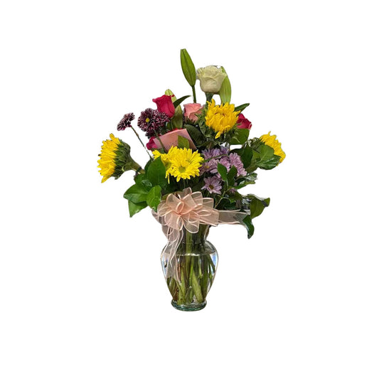 Spring sunshine vase arrangement with sunflowers roses lilies and fresh greenery by Houston florist