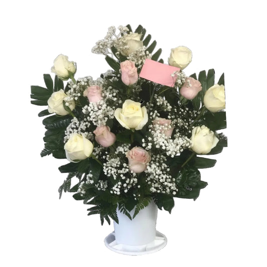 White and blush rose vase arrangement with baby breath and fresh greenery by Houston florist
