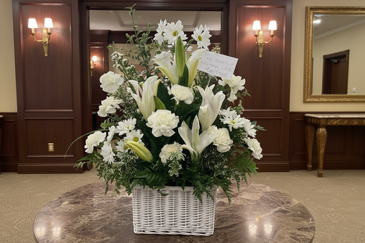 White funeral flower basket with lilies carnations daisies and greenery for Houston delivery