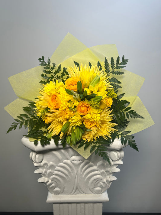 Yellow flower bouquet with roses, mums, lilies, and greenery from a Houston florist